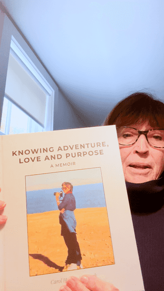 Carol holding her memoir